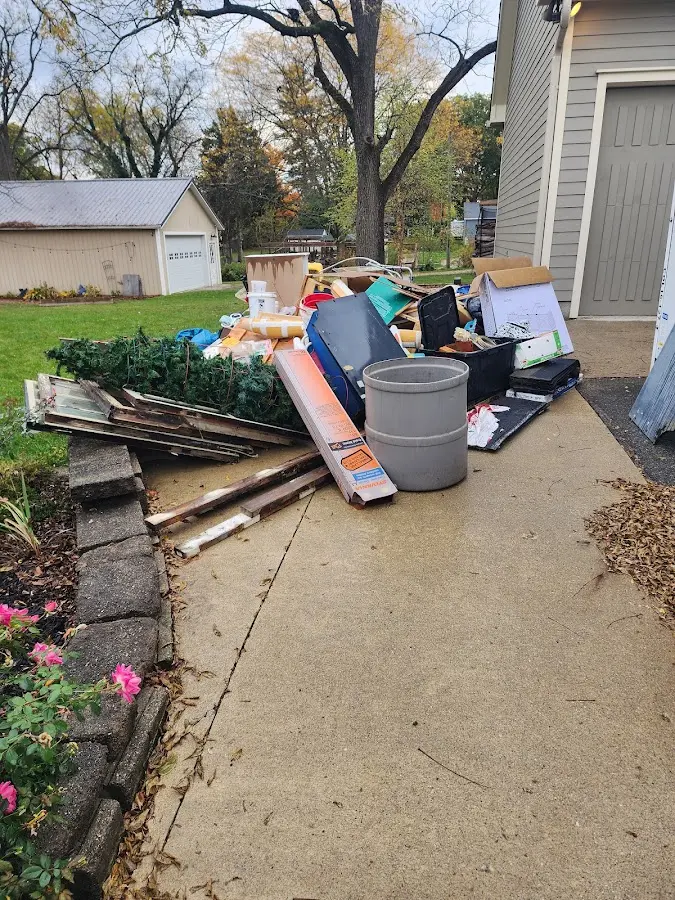 Dumpster being loaded with debris for Roofing Dumpster Rental in Tolono